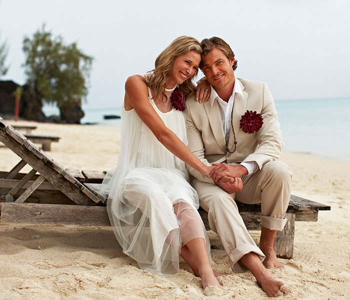 couple on a beach woman in wedding dress