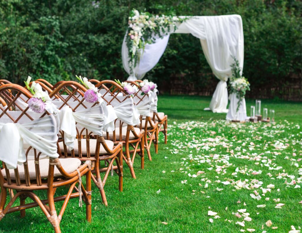 Outdoor wedding with arch and chairs