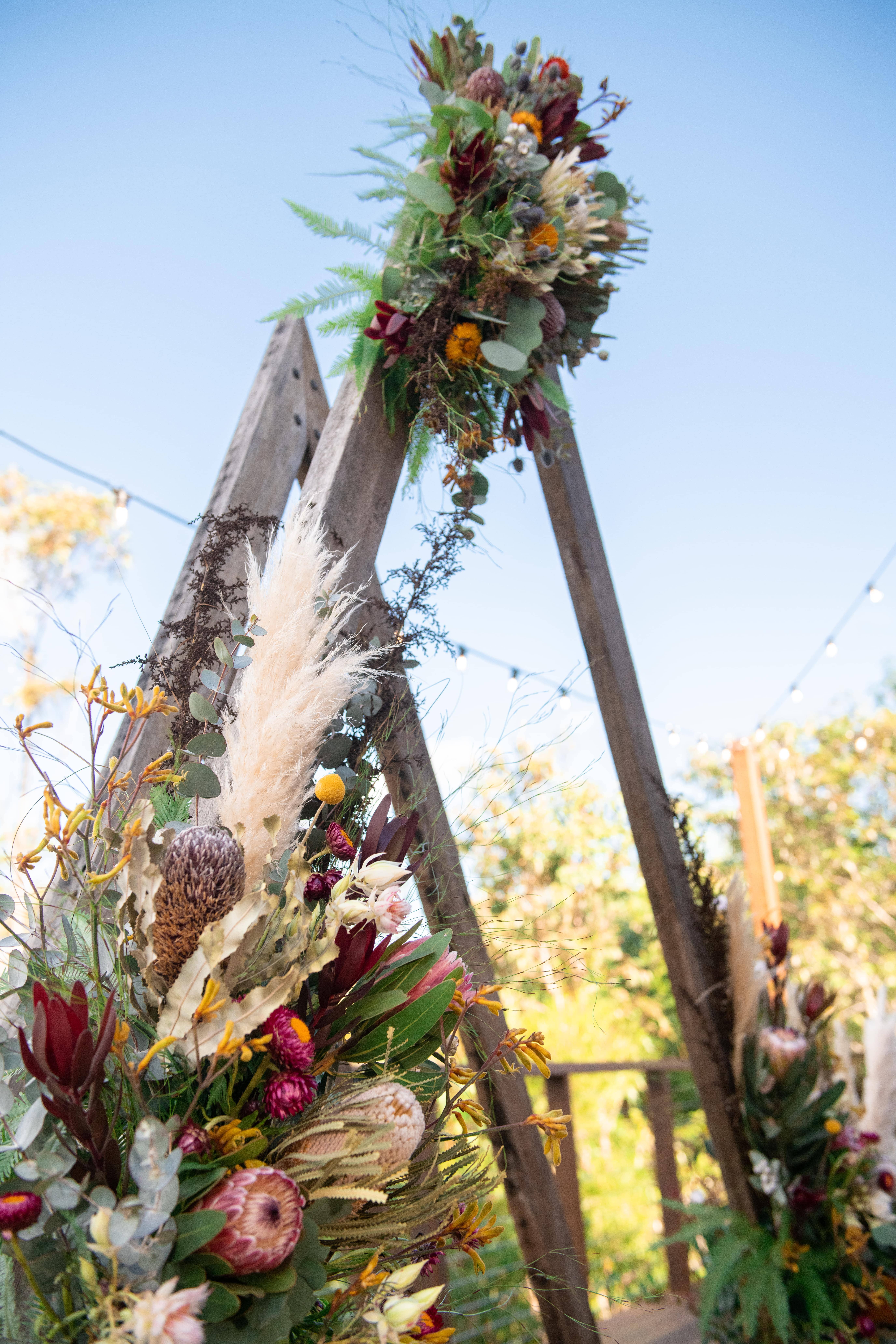 Real-wedding-Luke-and-Mitch-at-The-Crocodile-Lodge-Australia-Zoo-Queensland-wedding-arch-with-florals