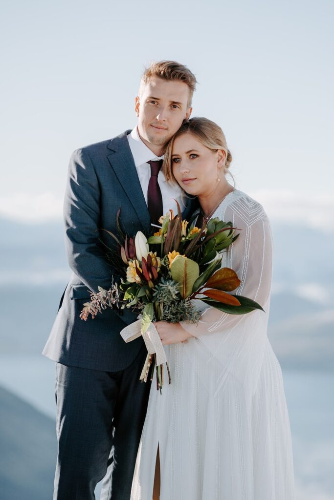 Real-wedding-Katie-and-Ben-New-Zealand-portrait-holding-flowers