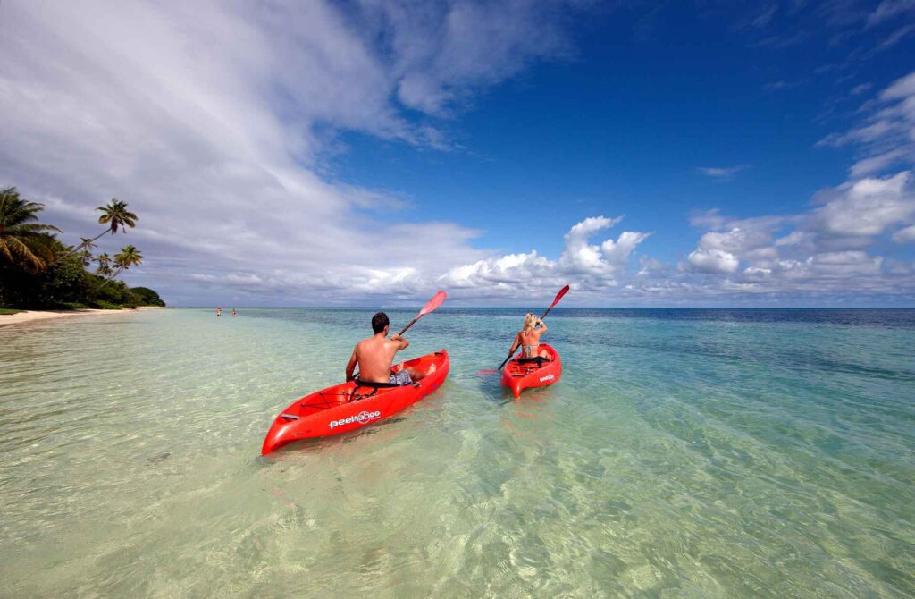 Lomani-island-resort-fiji-romantic-couple-kayaking-on-the-beach