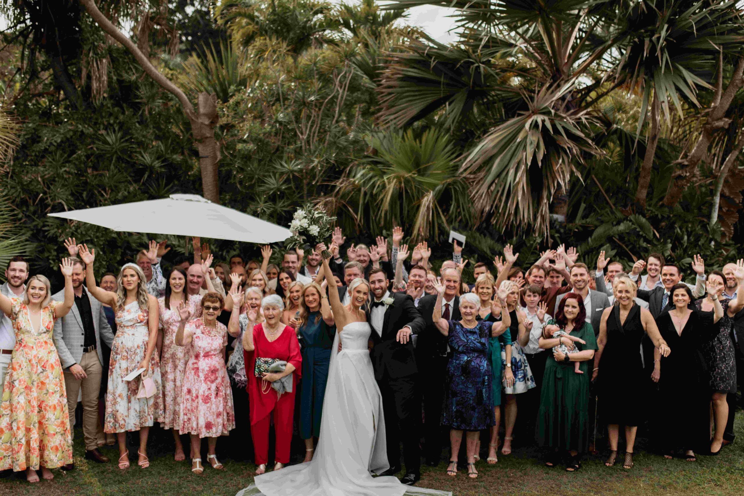Real-wedding-Teagan-and-Luke-Villa-Botanica-Whitsundays-Australia-by-Rolling-Portraits-post-ceremony-picture-of-the-bride-and-groom-with-all-guests-families-and-friends