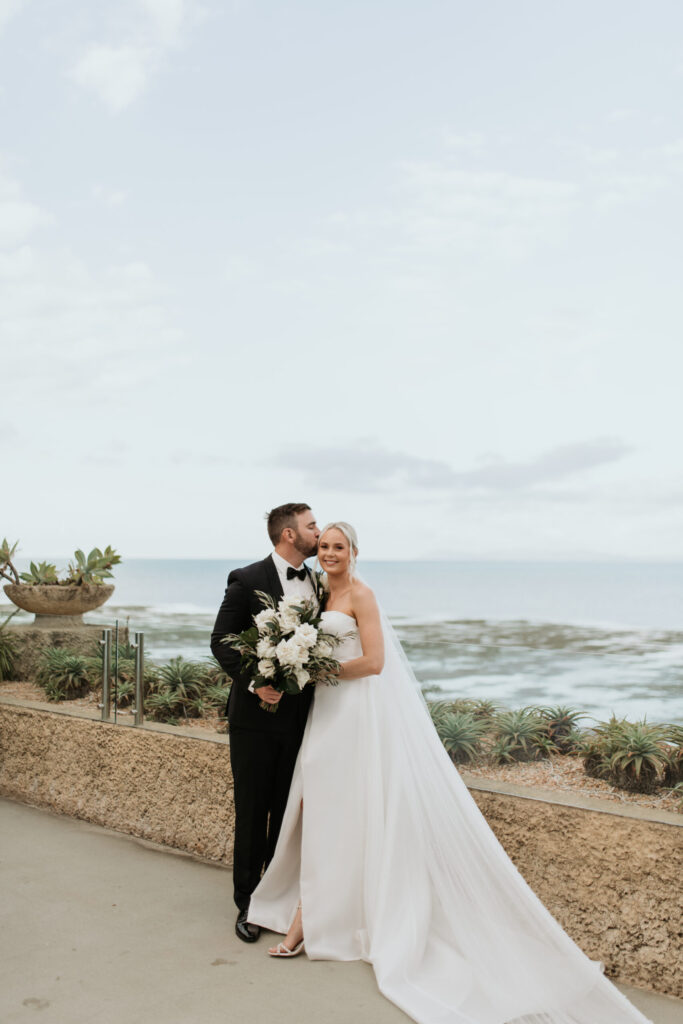 Real-wedding-Teagan-and-Luke-Villa-Botanica-Whitsundays-Australia-by-Rolling-Portraits-newlywed-portrait-groom-kissing-the-bride-on-the-forehead