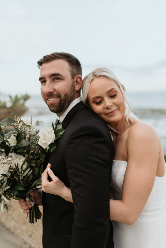 Real-wedding-Teagan-and-Luke-Villa-Botanica-Whitsundays-Australia-by-Rolling-Portraits-newlywed-portrait-bride-hugging-the-groom-from-behind