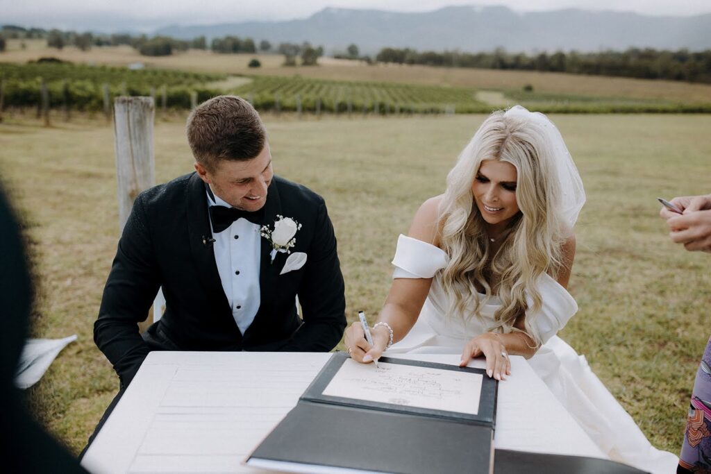 Real Wedding - Brittany + Edward - Bimbadgen Palmers Lane, Hunter Valley - The Beginning Studio - bride and groom signing wedding vows