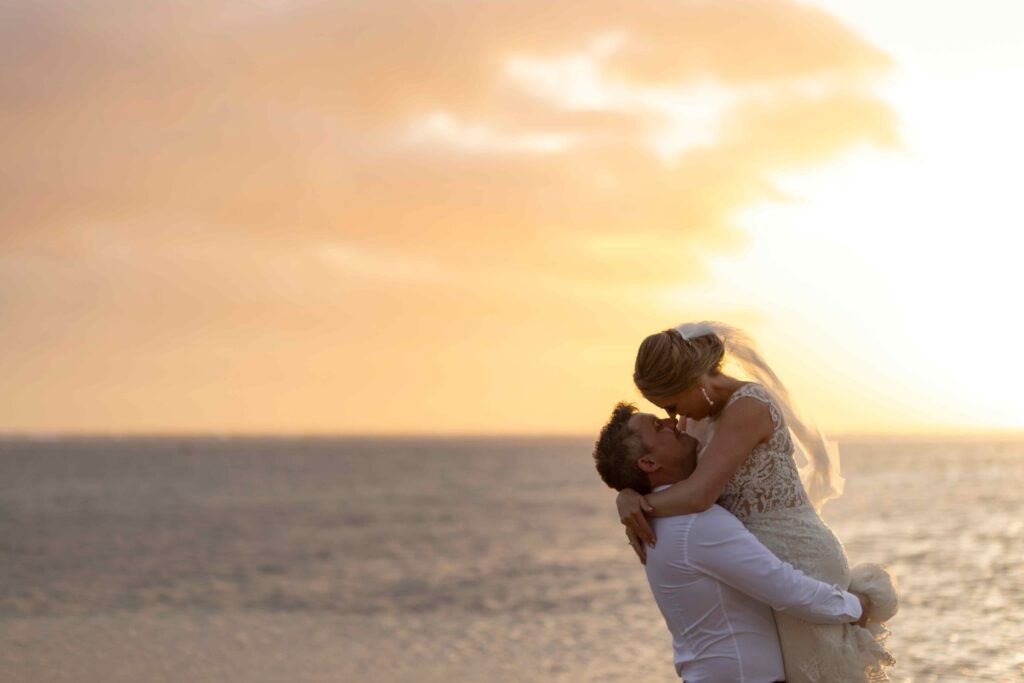 Kylee & Jason at Outrigger Fiji Beach Resort - images by Ocean Studio Fiji - bride and groom kissing portrait at the beach