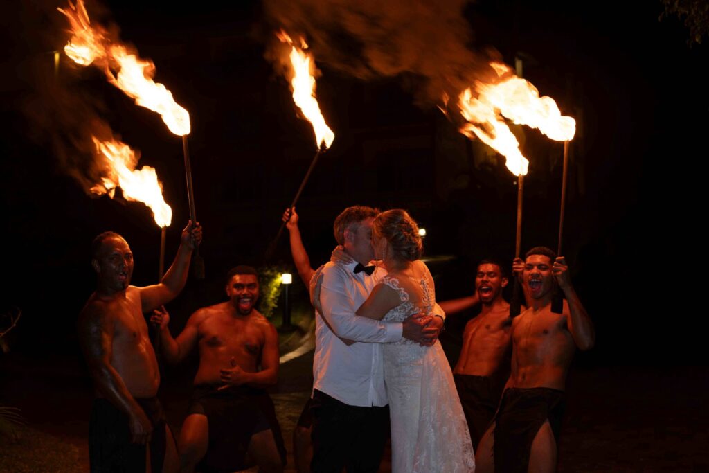 Kylee & Jason at Outrigger Fiji Beach Resort - images by Ocean Studio Fiji - bride and groom with fire dancers