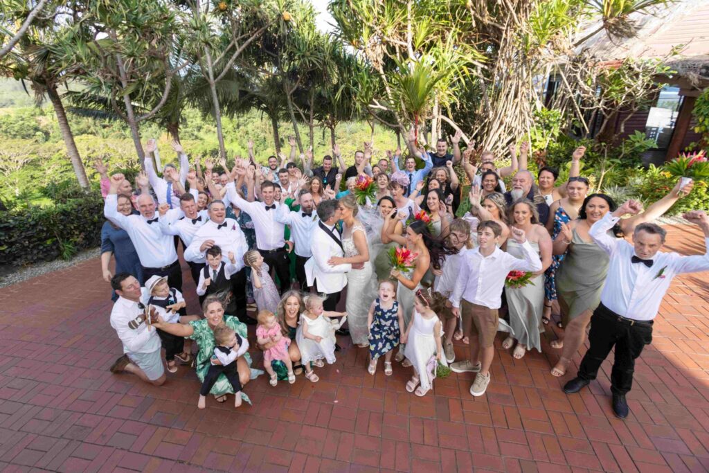Kylee & Jason at Outrigger Fiji Beach Resort - images by Ocean Studio Fiji - bride and groom with visitors holding hands up