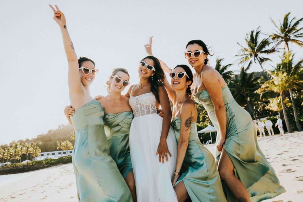 Real Wedding - Arthur and Gabby - Intercontinental Hayman Island by Timeless images by Vanessa - bride with bridesmaids by the beach