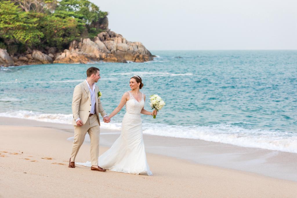 Real Wedding - Lucy + Liam, Garrya Tongsai Bay Samui - newlywed couple walking by the beach